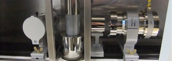 Equipment for Mössbauer spectroscopy:  drive unit with source (right), cryostat with sample inside (middle), and detector (left)
