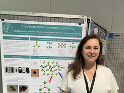 Natalia in front of her award-winning poster at SCTE-2022